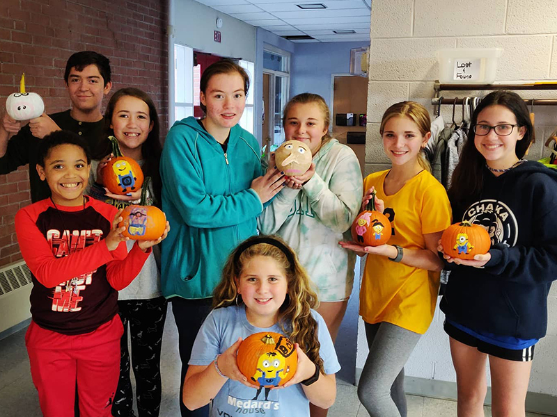 Group of PreTeens and Teens Show Off Painted Pumpins